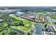 Scenic aerial view of property near golf course, lakes, and lush green landscape at 4175 Muirfield Loop, Lake Wales, FL 33859