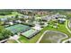 Aerial view of tennis, bocce ball and lake at 4175 Muirfield Loop, Lake Wales, FL 33859