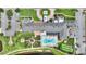 Bird's-eye view of the clubhouse featuring a pool, gardens, parking, fountain, and beautiful grounds from an aerial perspective at 4175 Muirfield Loop, Lake Wales, FL 33859