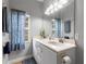 Bathroom featuring double sinks, vanity, and decorative window with patterned curtains at 4175 Muirfield Loop, Lake Wales, FL 33859