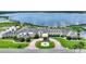 Stunning aerial view of clubhouse with lush landscaping and water views at 4175 Muirfield Loop, Lake Wales, FL 33859