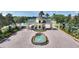 Lake Ashton community entrance featuring a fountain, lush landscaping and manned security gate at 4175 Muirfield Loop, Lake Wales, FL 33859