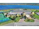Aerial view of the clubhouse overlooking a lake, with manicured landscaping and convenient parking at 4175 Muirfield Loop, Lake Wales, FL 33859