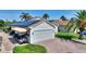 View of a home with a brick driveway, showcasing solar panels and a convenient golf cart at 4175 Muirfield Loop, Lake Wales, FL 33859