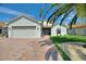 Charming single-story home featuring an attached garage, well-manicured lawn, and beautiful landscaping at 4175 Muirfield Loop, Lake Wales, FL 33859