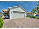 Spacious two-car garage with awning and brick driveway, situated in a pristine community at 4175 Muirfield Loop, Lake Wales, FL 33859