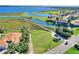 Aerial view of golf course and waterfront homes, with a wooden cart path in a scenic community at 4175 Muirfield Loop, Lake Wales, FL 33859