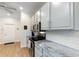 Kitchen showcasing white cabinets, stainless steel appliances, and designer backsplash at 4175 Muirfield Loop, Lake Wales, FL 33859