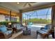 Inviting lanai features comfortable wicker seating, a ceiling fan, and views of the pool area at 4175 Muirfield Loop, Lake Wales, FL 33859