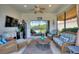 Cozy lanai with comfortable wicker furniture, perfect for relaxing and enjoying the outdoor view at 4175 Muirfield Loop, Lake Wales, FL 33859