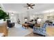 Bright open-concept living room with a ceiling fan, modern furniture, and lots of natural light at 4175 Muirfield Loop, Lake Wales, FL 33859