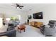 Spacious living room with light-colored walls, a ceiling fan, and comfortable seating at 4175 Muirfield Loop, Lake Wales, FL 33859