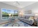 Bright living space with a view of the pool, a small desk and a large window at 4175 Muirfield Loop, Lake Wales, FL 33859