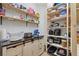 Pantry with wood shelves and cabinets, offering storage space for kitchen items at 4175 Muirfield Loop, Lake Wales, FL 33859