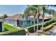 Home featuring a pool, screened in patio, tropical landscaping, and solar panels at 4175 Muirfield Loop, Lake Wales, FL 33859
