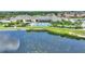 Aerial view of community pool overlooking beautiful water and landscape at 4175 Muirfield Loop, Lake Wales, FL 33859