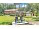 Expansive backyard with mature trees, pool, and seating area perfect for outdoor enjoyment at 418 North Rd, Lakeland, FL 33809