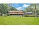 Lush backyard featuring mature trees, well-manicured lawn, and a glimpse of the house at 418 North Rd, Lakeland, FL 33809