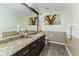 Bright bathroom with a large mirror, granite countertop vanity and wood look flooring at 418 North Rd, Lakeland, FL 33809