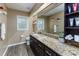 Bathroom boasts a spacious granite counter, dark wood cabinets, and wood-look floors at 418 North Rd, Lakeland, FL 33809