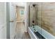 Bathroom with glass shower door and wood-look floors extends to the toilet and sink area at 418 North Rd, Lakeland, FL 33809