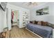 Bedroom with a cozy daybed, hardwood floors, and a walk-in closet workspace at 418 North Rd, Lakeland, FL 33809