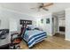 Cozy bedroom with a ceiling fan, a gaming desk, and a view to another room at 418 North Rd, Lakeland, FL 33809