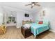 Bedroom featuring a cozy window seat, a ceiling fan, and a turquoise bedspread at 418 North Rd, Lakeland, FL 33809