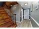 Inviting entryway with wood staircase, gray walls with white trim, and wood-look floors at 418 North Rd, Lakeland, FL 33809