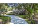 Beautifully landscaped home with a long, curved driveway surrounded by mature trees, offering a private setting at 418 North Rd, Lakeland, FL 33809