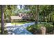 Beautifully landscaped home with a long, curved driveway surrounded by mature trees, offering a private setting at 418 North Rd, Lakeland, FL 33809