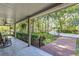 Inviting front porch with comfortable seating, overlooking a beautifully landscaped yard and a brick pathway at 418 North Rd, Lakeland, FL 33809