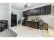Kitchen featuring black appliances, wooden cabinets, and a colorful tile backsplash at 418 North Rd, Lakeland, FL 33809