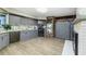 Modern kitchen features gray cabinetry, stainless appliances, and brick accent wall at 418 North Rd, Lakeland, FL 33809