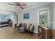 Living room with wood flooring, grey furniture, and access to the bedroom at 418 North Rd, Lakeland, FL 33809