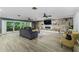 Spacious living room features a stone accent wall with a fireplace and sliding glass doors at 418 North Rd, Lakeland, FL 33809