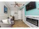 Cozy living room with fireplace, ceiling fan, wood flooring, and neutral-toned furniture at 418 North Rd, Lakeland, FL 33809