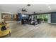 Bright living room featuring contemporary decor, ceiling fans, and sliding glass doors to the patio at 418 North Rd, Lakeland, FL 33809