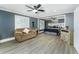 Main bedroom with seating area, ceiling fan, and open access to sleeping area with a king size bed at 418 North Rd, Lakeland, FL 33809