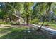 Charming outbuilding with brick siding and walkway nestled in a serene, wooded landscape at 418 North Rd, Lakeland, FL 33809