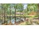 Scenic pond view reflecting the main house and the outbuilding for a peaceful setting at 418 North Rd, Lakeland, FL 33809