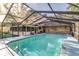 A screened-in pool with brick home and lounge area offering a relaxing outdoor living space at 418 North Rd, Lakeland, FL 33809