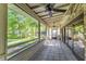 Spacious screened-in porch with ceiling fans, tile floor, and a view of the backyard at 418 North Rd, Lakeland, FL 33809