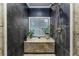 Modern tiled shower with a window and a built-in bench for storage or decor at 418 North Rd, Lakeland, FL 33809