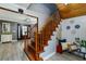 Elegant wooden staircase with a cozy landing and decorative accents, showcasing the home's interior design at 418 North Rd, Lakeland, FL 33809