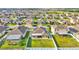 Expansive aerial view of homes with well-manicured lawns and solar panels in a vibrant community at 428 Aragosa Dr, Davenport, FL 33837