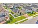 Aerial view of a home with a well-kept lawn and solar panels in a neatly planned community at 428 Aragosa Dr, Davenport, FL 33837