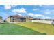 Spacious backyard featuring a well-maintained lawn, a privacy fence, and a view of the home's exterior at 428 Aragosa Dr, Davenport, FL 33837