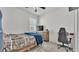 Well-lit bedroom features a ceiling fan, window, and a dresser with a mounted television at 428 Aragosa Dr, Davenport, FL 33837