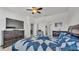 An expansive bedroom features a stylish blue quilt and complementing furnishings at 428 Aragosa Dr, Davenport, FL 33837